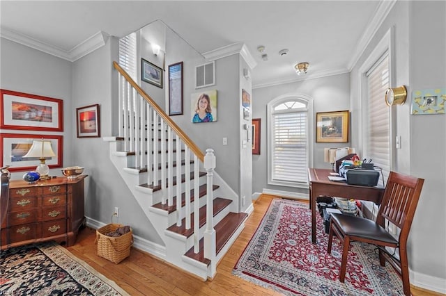 foyer featuring hardwood / wood-style floors and ornamental molding