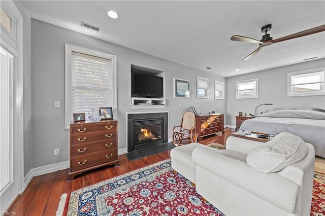 living room with ceiling fan and dark wood-type flooring