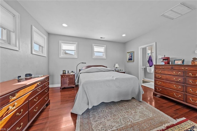 bedroom featuring a closet, a spacious closet, and dark hardwood / wood-style flooring