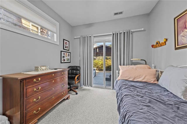 carpeted bedroom with access to outside and multiple windows