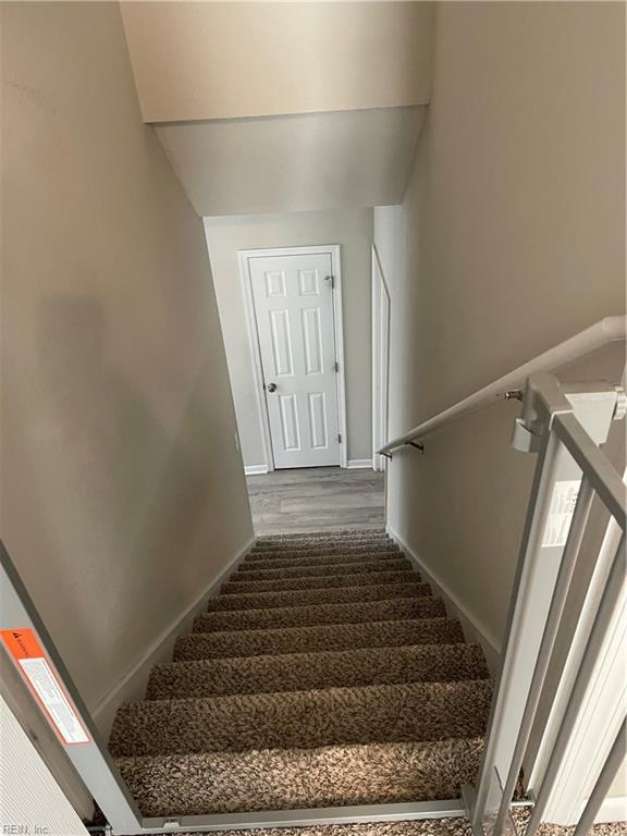 stairs featuring baseboards and wood finished floors