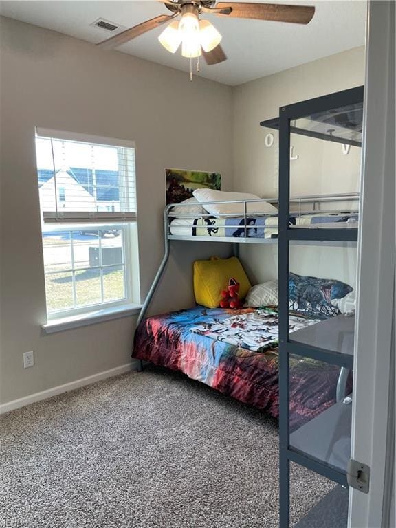 bedroom featuring ceiling fan, carpet flooring, visible vents, and baseboards