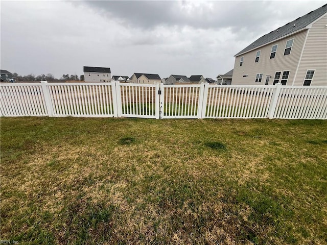 view of yard with a residential view and fence