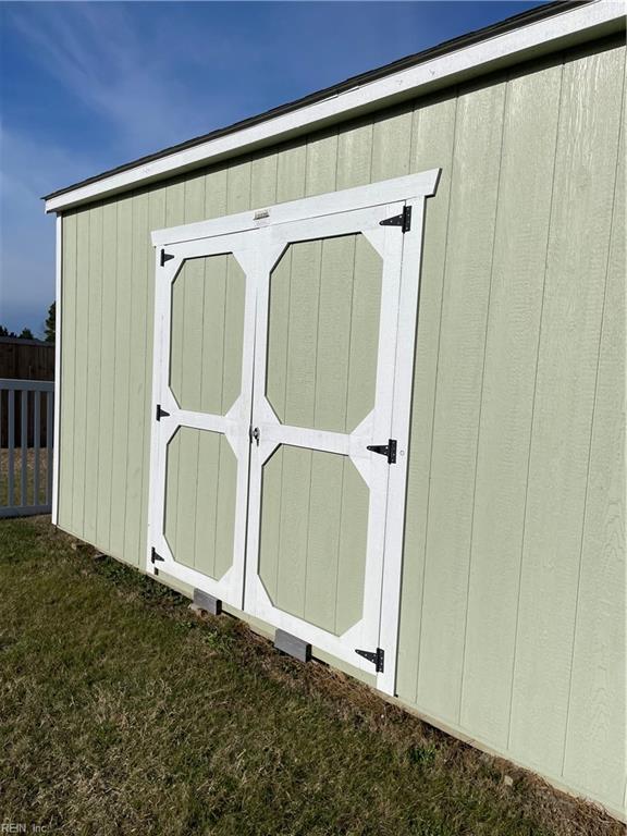 view of shed featuring fence