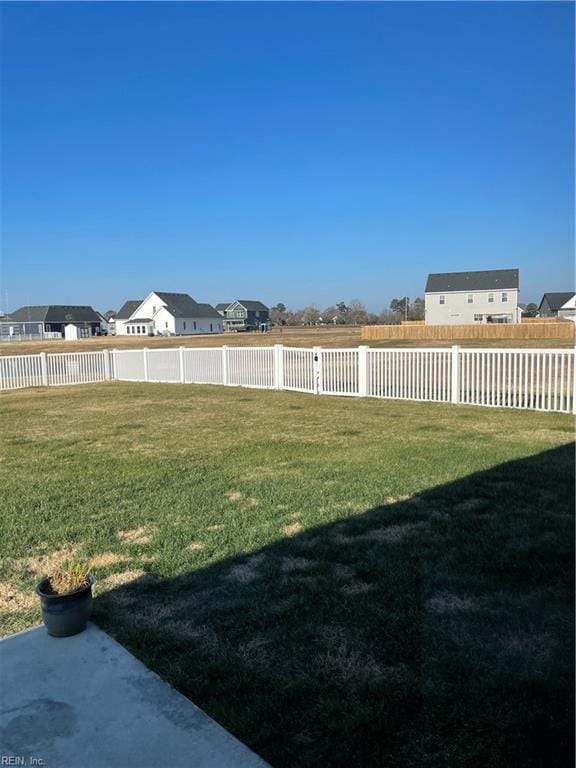 view of yard featuring a residential view and a fenced backyard