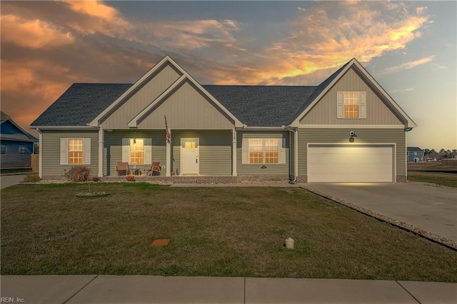 craftsman-style home featuring a garage, a shingled roof, concrete driveway, covered porch, and a front yard