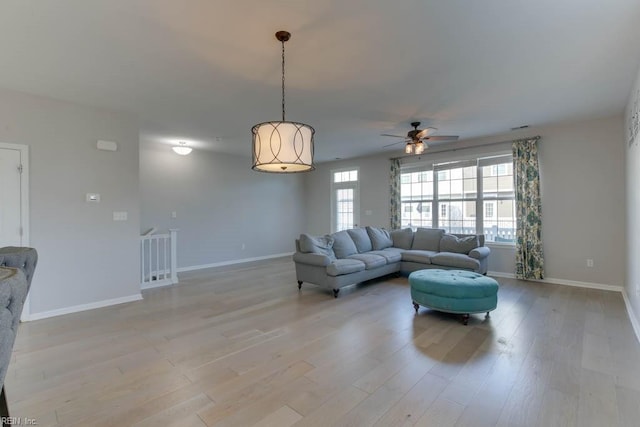 living room with light wood-type flooring and ceiling fan