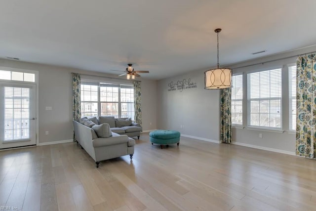 living room featuring ceiling fan and light wood-type flooring