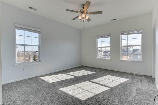 unfurnished room featuring ceiling fan and dark colored carpet