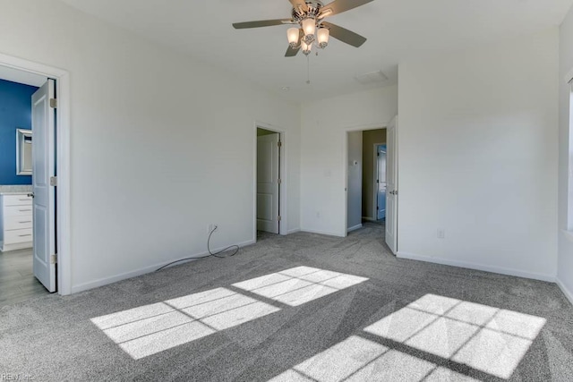 interior space featuring light carpet, ceiling fan, and ensuite bath