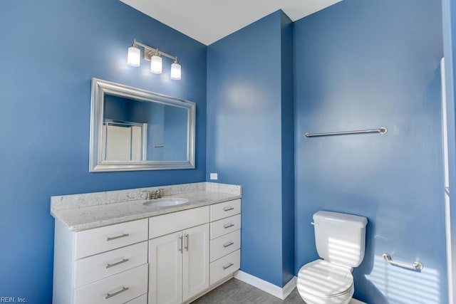 bathroom with toilet and vanity