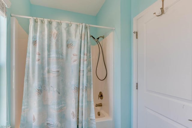 bathroom with shower / bath combination with curtain