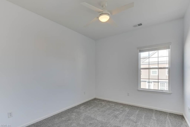 empty room featuring ceiling fan and light colored carpet