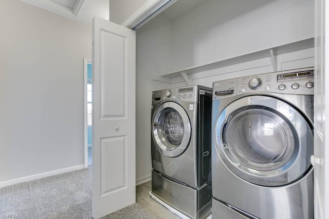 washroom featuring separate washer and dryer and light carpet