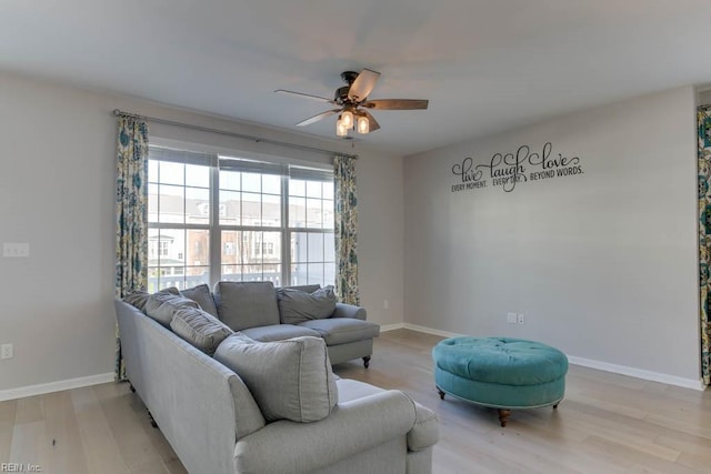 living room with ceiling fan and light wood-type flooring