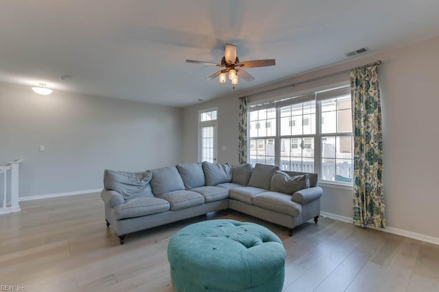 living room featuring light hardwood / wood-style floors and ceiling fan