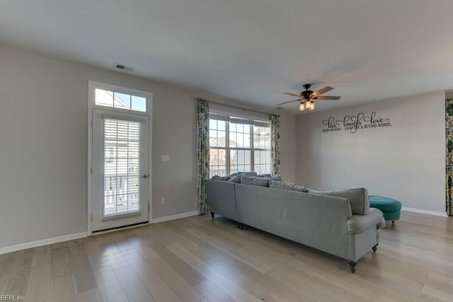 unfurnished living room featuring ceiling fan and light hardwood / wood-style floors