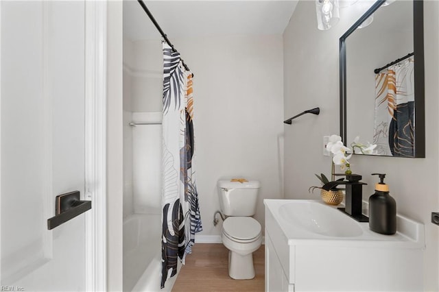 full bathroom with vanity, hardwood / wood-style flooring, toilet, and shower / bath combo with shower curtain