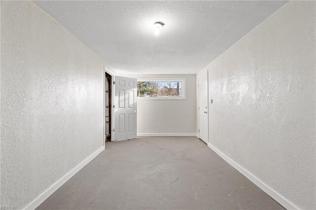 interior space with concrete flooring and a textured ceiling