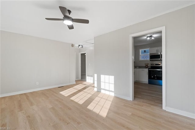 unfurnished room with ceiling fan and light wood-type flooring