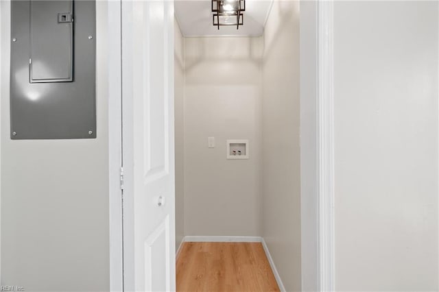 laundry area with electric panel, washer hookup, and hardwood / wood-style flooring