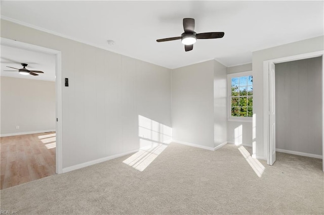 unfurnished bedroom with ceiling fan and light colored carpet