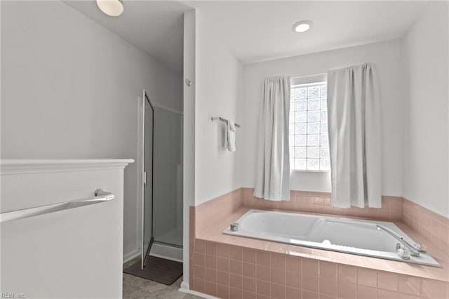 bathroom featuring tile patterned flooring and shower with separate bathtub