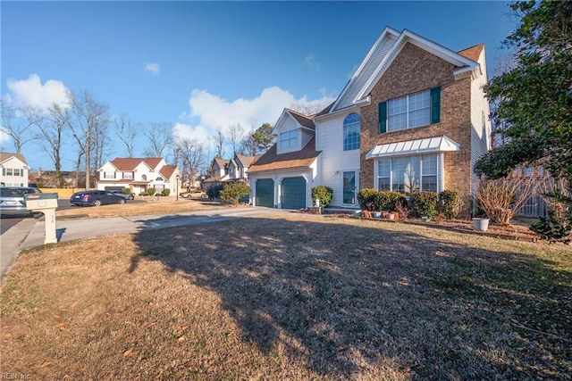 view of property with a garage and a front lawn