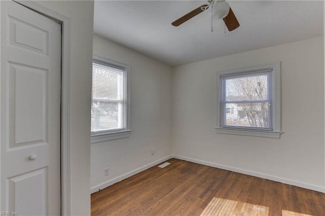 empty room with ceiling fan and wood-type flooring