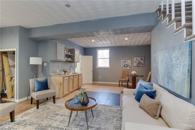 living room featuring sink and light tile patterned floors