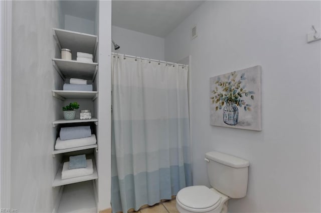 bathroom with toilet and walk in shower