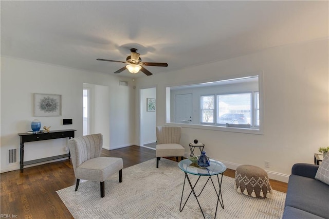 living area featuring dark hardwood / wood-style floors and ceiling fan