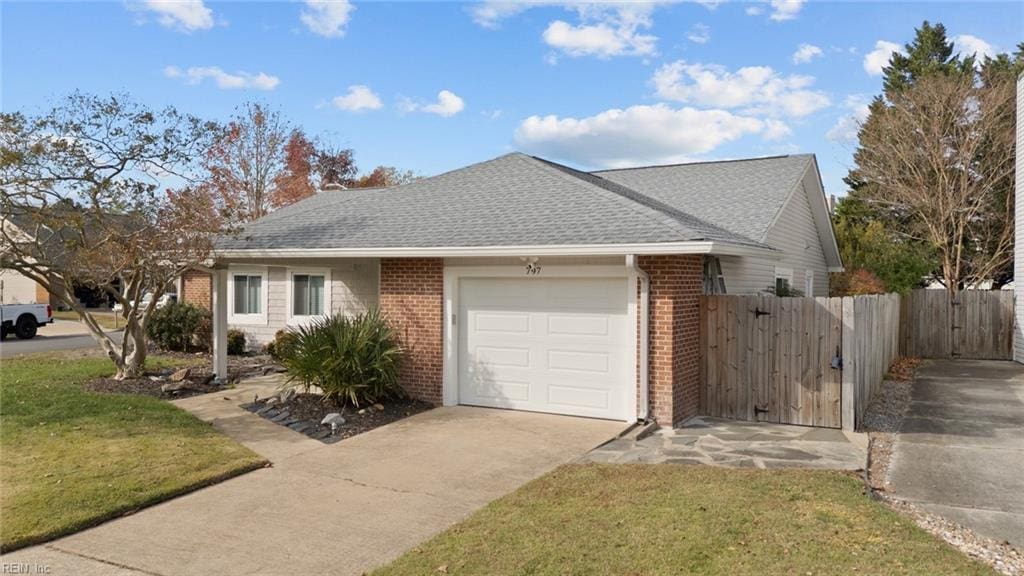 single story home with a front yard and a garage