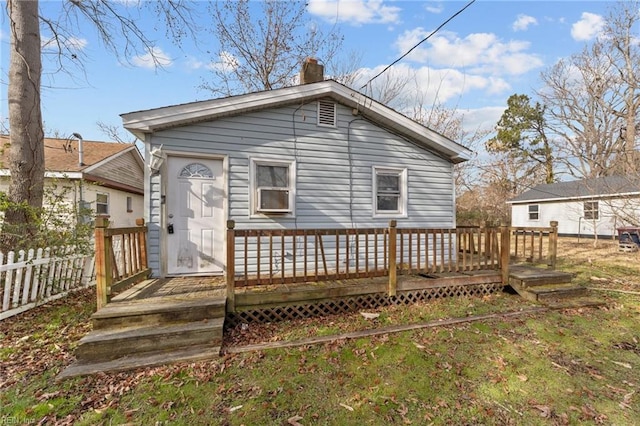 rear view of house with a wooden deck