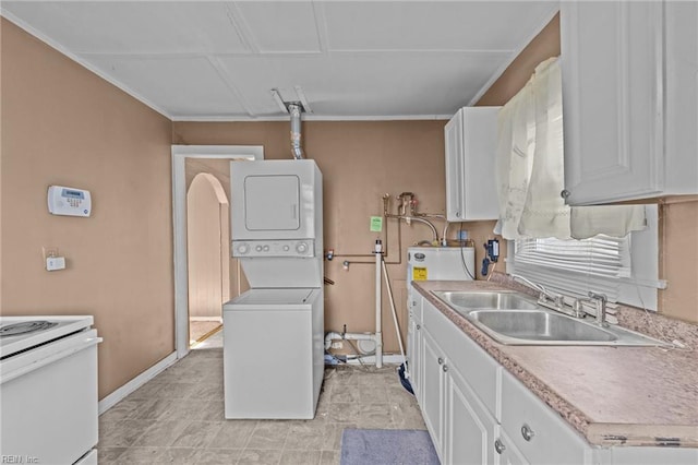 kitchen with electric range, white cabinetry, stacked washer / drying machine, and sink