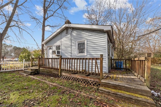 back of house featuring a wooden deck