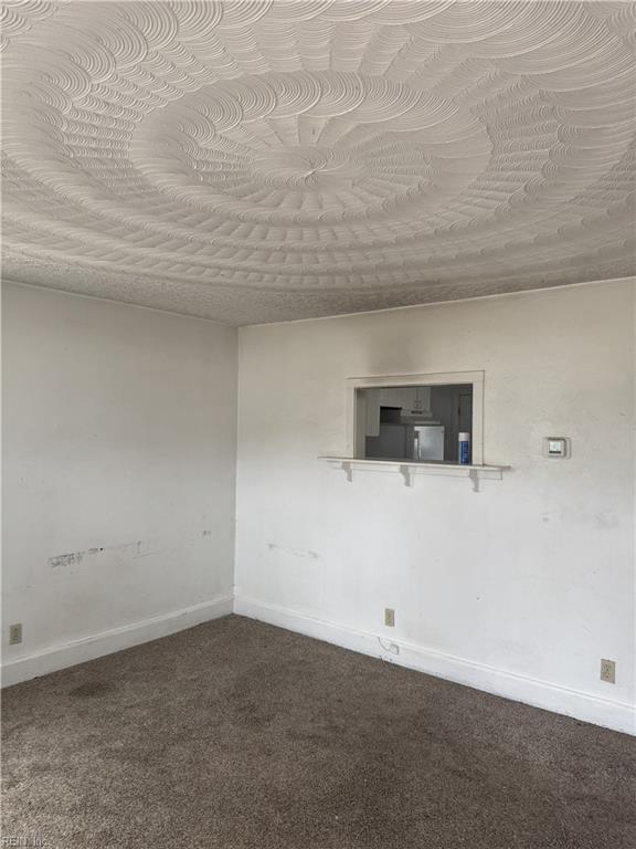 409 Hicks Ave, Norfolk, VA 23502 - unfurnished room with baseboards and dark colored carpet