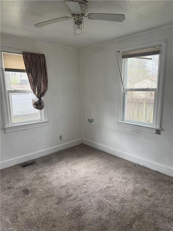 409 Hicks Ave, Norfolk, VA 23502 - unfurnished room with visible vents, baseboards, carpet, and ceiling fan