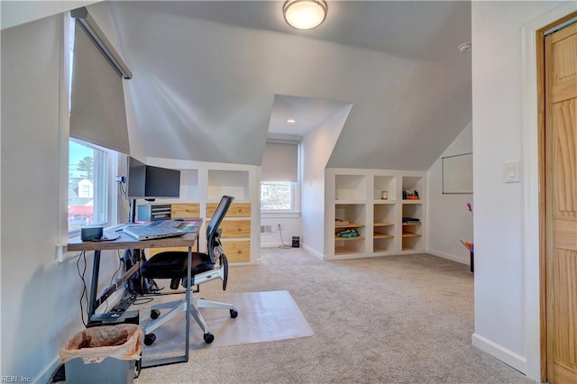 office area with light carpet, built in features, and lofted ceiling