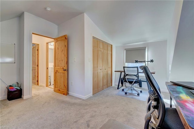 office space featuring light colored carpet and lofted ceiling