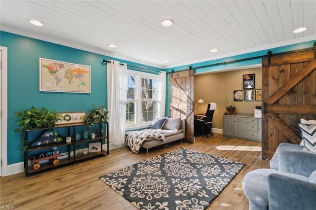 living area featuring hardwood / wood-style flooring, a barn door, and wooden ceiling