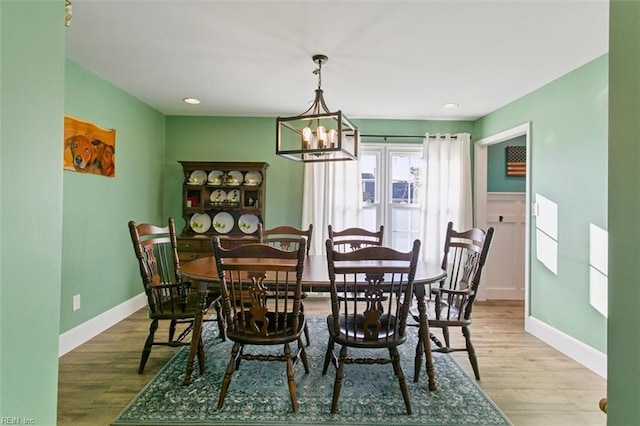 dining space featuring a notable chandelier and light hardwood / wood-style flooring