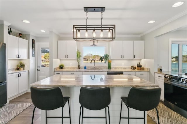 kitchen with white cabinetry, a center island, and stainless steel appliances