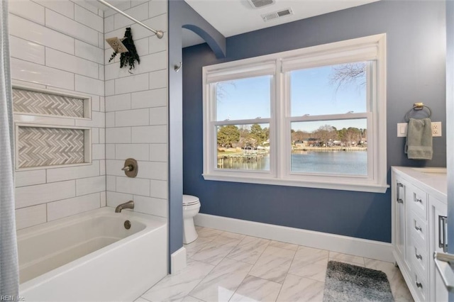 full bathroom with vanity, a water view, tiled shower / bath, and a wealth of natural light