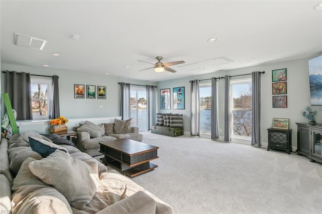 carpeted living room featuring ceiling fan