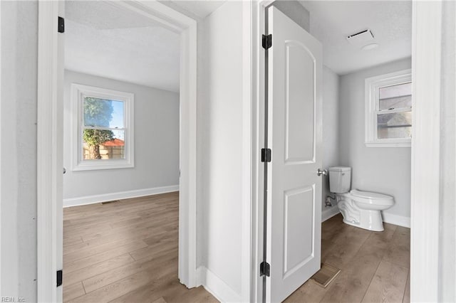 bathroom featuring hardwood / wood-style floors and toilet