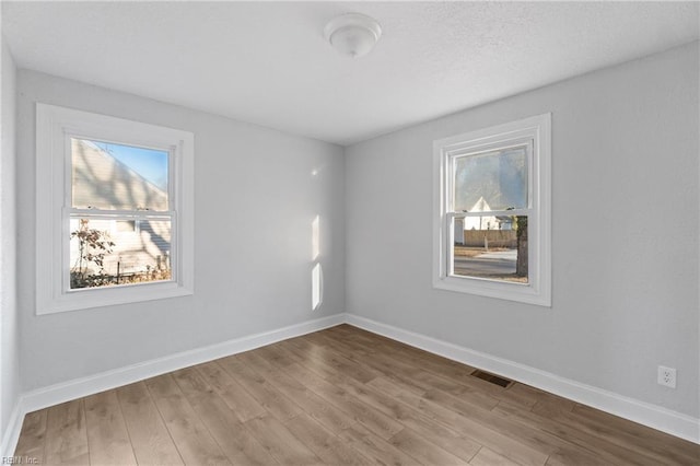 spare room featuring light wood-type flooring