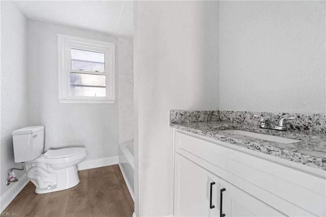 bathroom featuring vanity, hardwood / wood-style flooring, and toilet