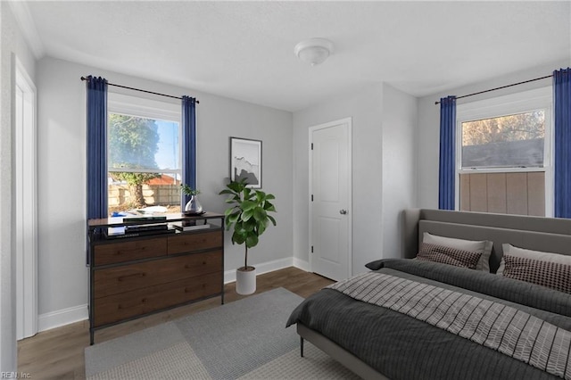 bedroom with dark hardwood / wood-style flooring