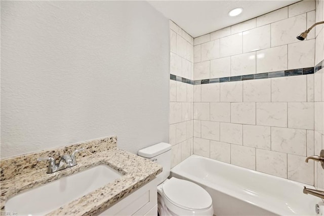 full bathroom with vanity, toilet, and tiled shower / bath